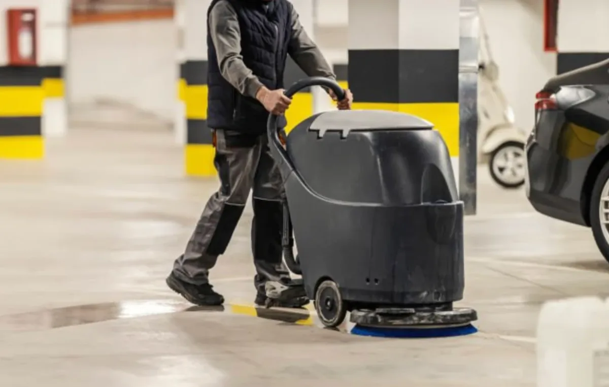 Parkade floor cleaning with a ride-on scrubber